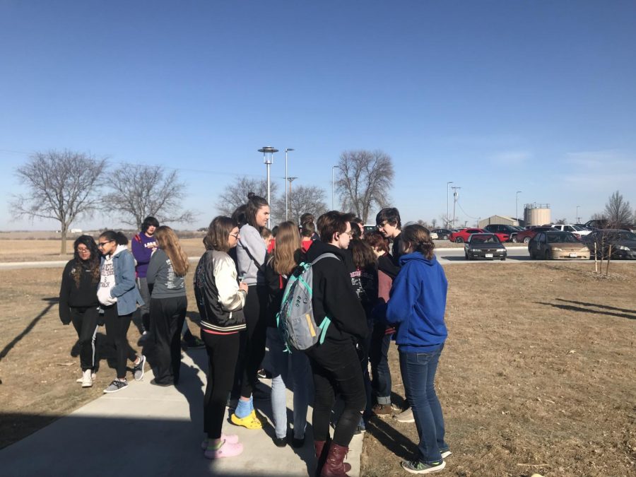Students gather in discussion during a school walk out.