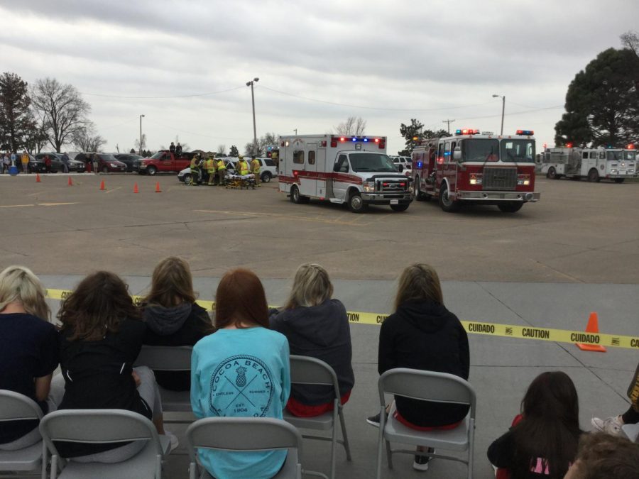 Students watch as they see their classmates put into emergency vehicles (mock accident).