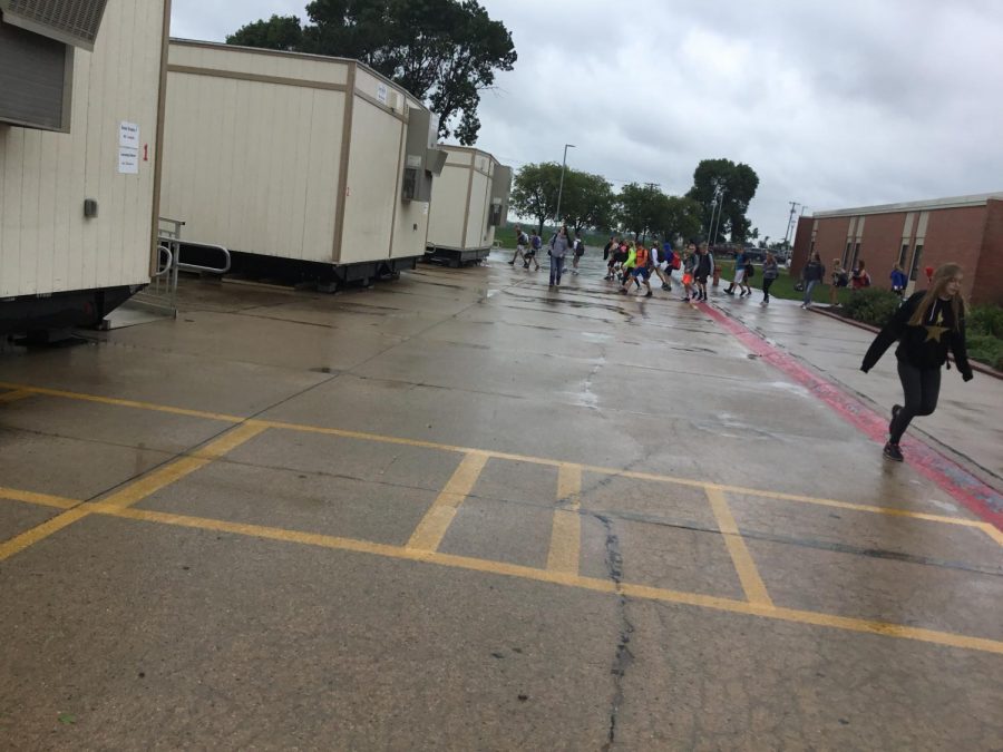 Middle school students dodged raindrops getting to outside classrooms.