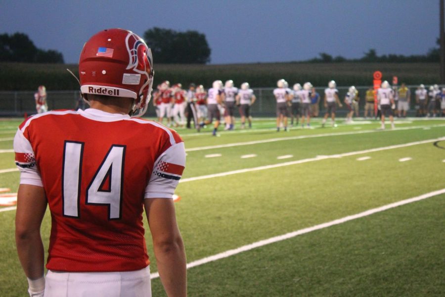 Senior quarterback Luke Partusch surveys the scene as Platteview’s defense takes the field. The Trojans came back to win against Lincoln Christian 22-15.