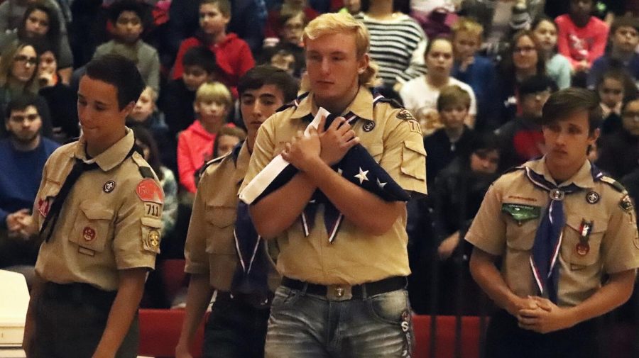 Eagle Scout candidates Mitchell Rudie, Jack Parr, Jake Nelson, and Tyler Kraus exit the stage after folding the American flag.