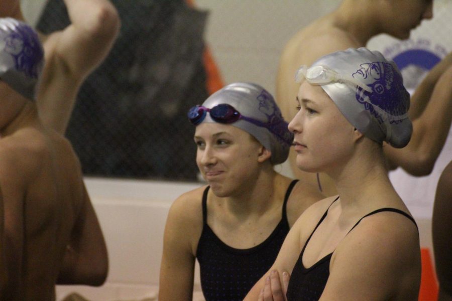 Elise Lutz and Madison Nash watch their teammates before their heat.