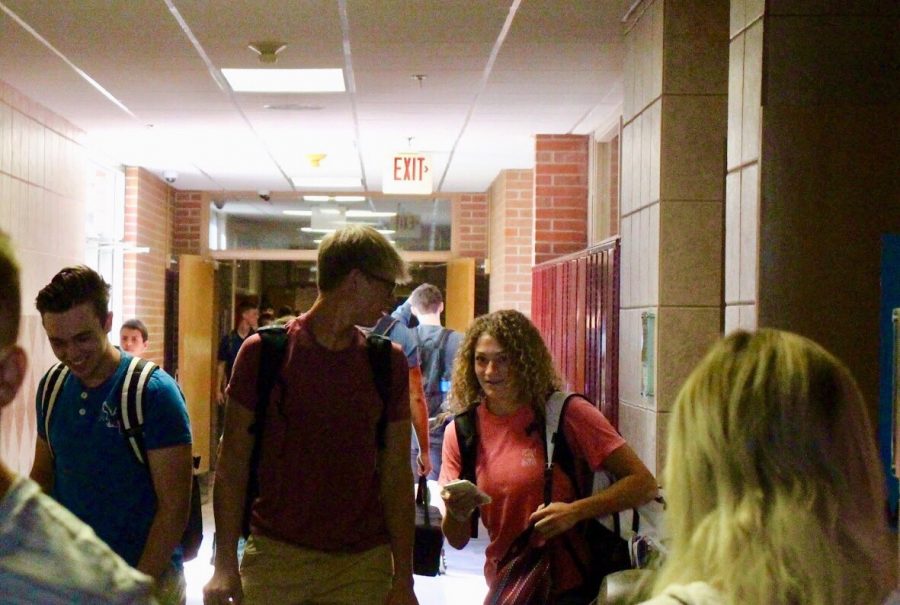 New seniors Byron Ehrke, Cade Demro, and Halle Johnson laugh in the west hall while walking to their classes on the first day of school, August 14th. 