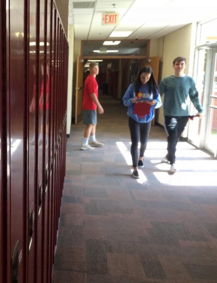 Seniors Laura Kinney and Conner Nelson have a relaxed end-of-the-day stroll through the halls. Kinney gives freshmen important advice as they begin their first year of high school.