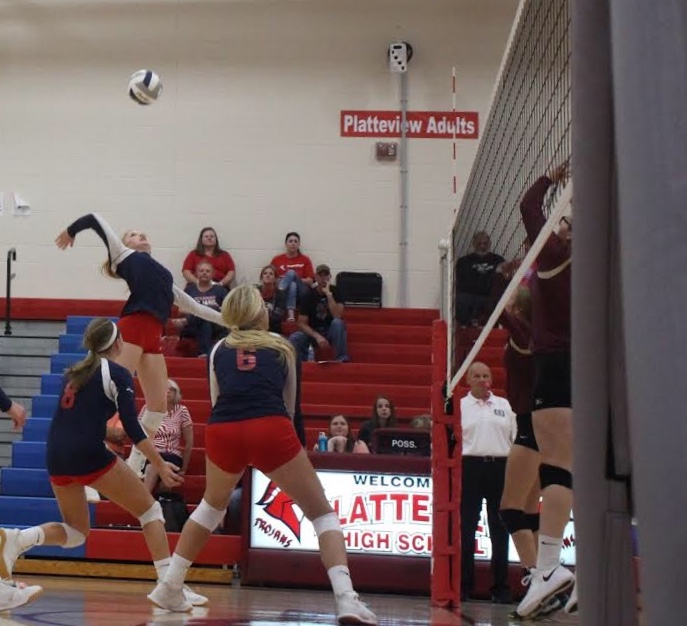 Anna Koehler jumps to spike the ball at the Varsity Volleyball Game on September 5 against Arlington.
