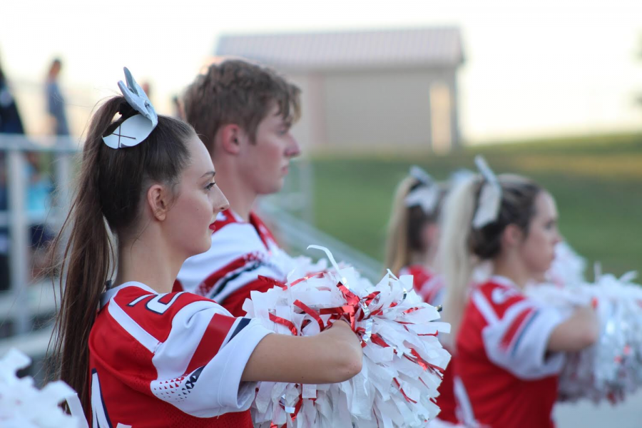 Ella+Kiger+stands+at+attention+during+the+playing+of+the+national+anthem+at+the+Homecoming+football+game.+