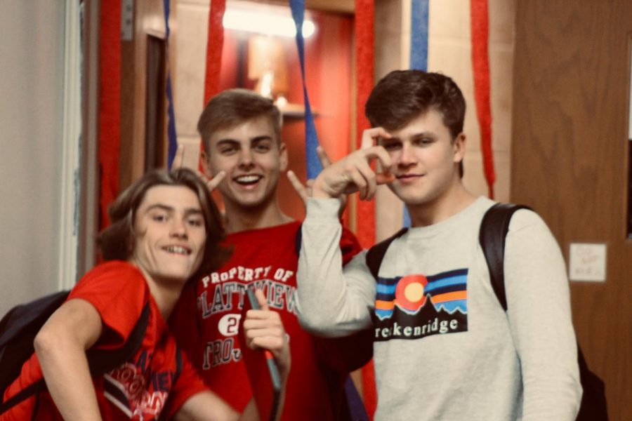 Seniors James Schulze, Colton Pugh, and Garrett Harrah pause for a picture in the hallway.