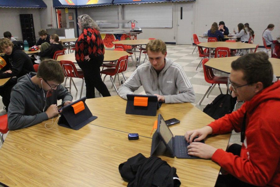 Students in study hall prepare for the day, working on assignments.