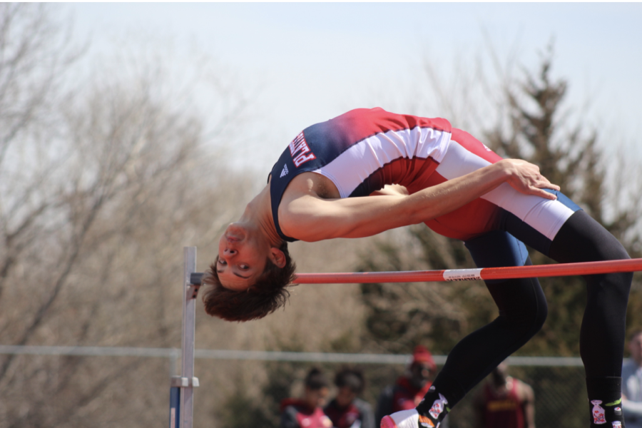 Leaping for Glory: Chase Wienk performing in the high jump, launches himself over the pole during the track meet at Platteview High School.