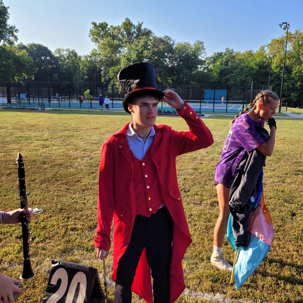 Jude Perry (11) puts on his top hat while getting ready for the marching band to perform the greatest show. 