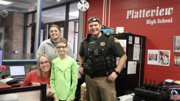 Staff and students spend time with Deputy Johnny Sanderson in the office.
