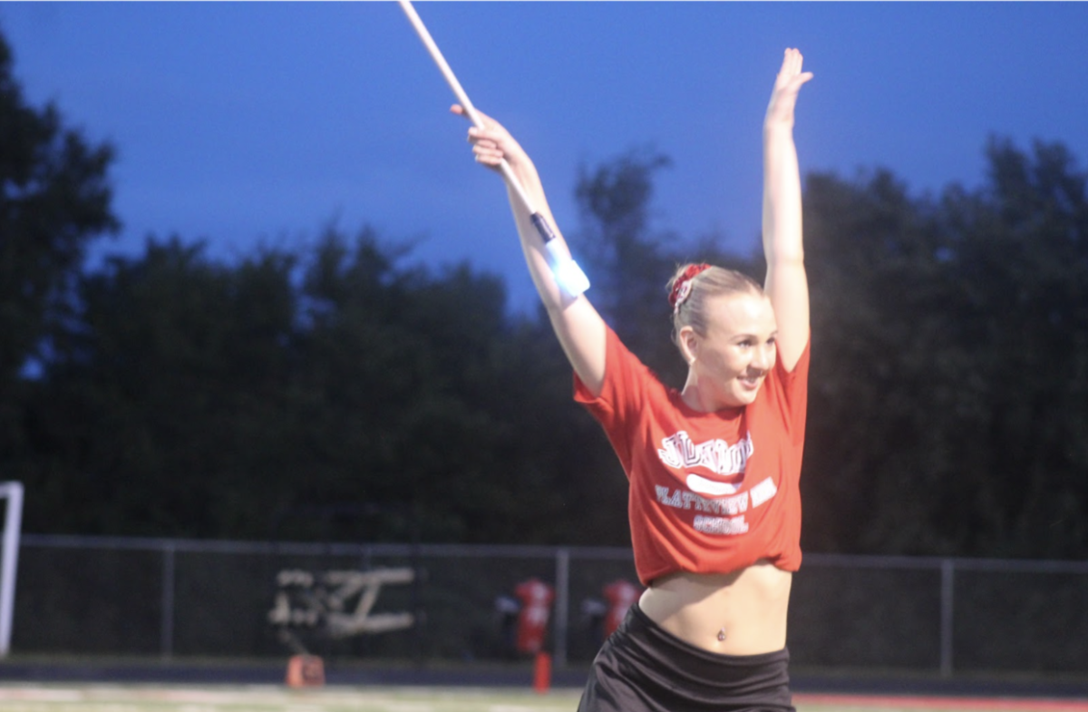 Presley+Smith+strikes+a+pose+between+baton+tosses+during+the+Marching+Band+performance+at+Platteview+High+School.%0A