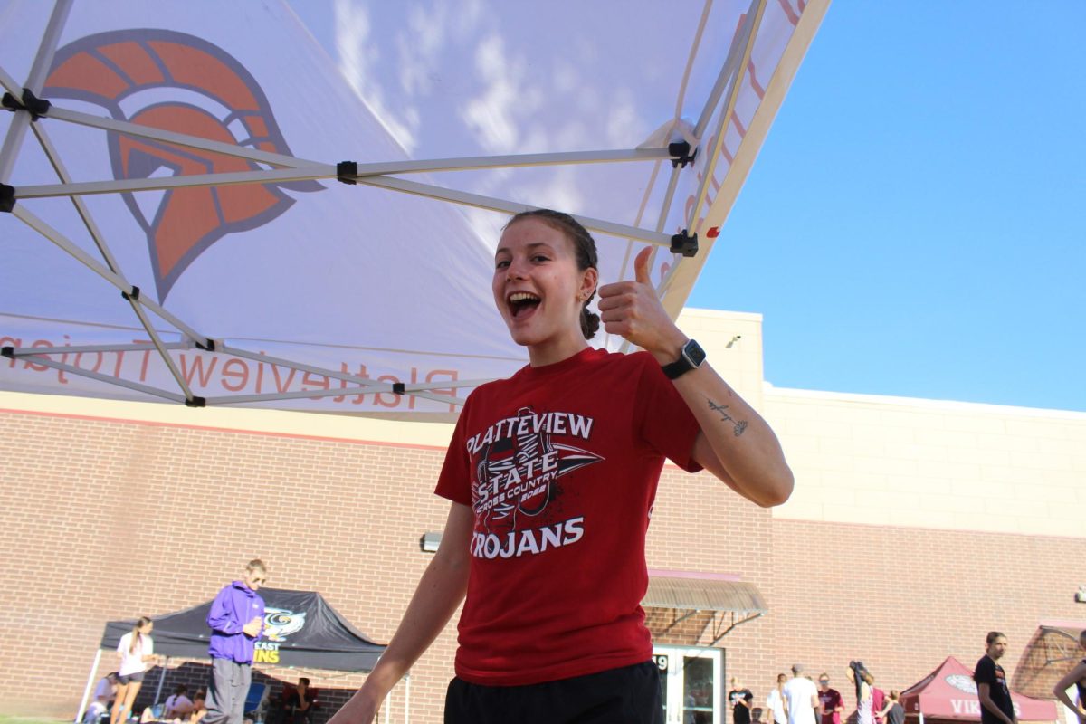 Lydia Stewart (12) stays positive at a cross country meet.