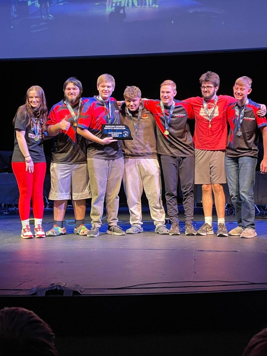 Top Dog: The Overwatch 2 team standing side by side as they show off their victory trophy.