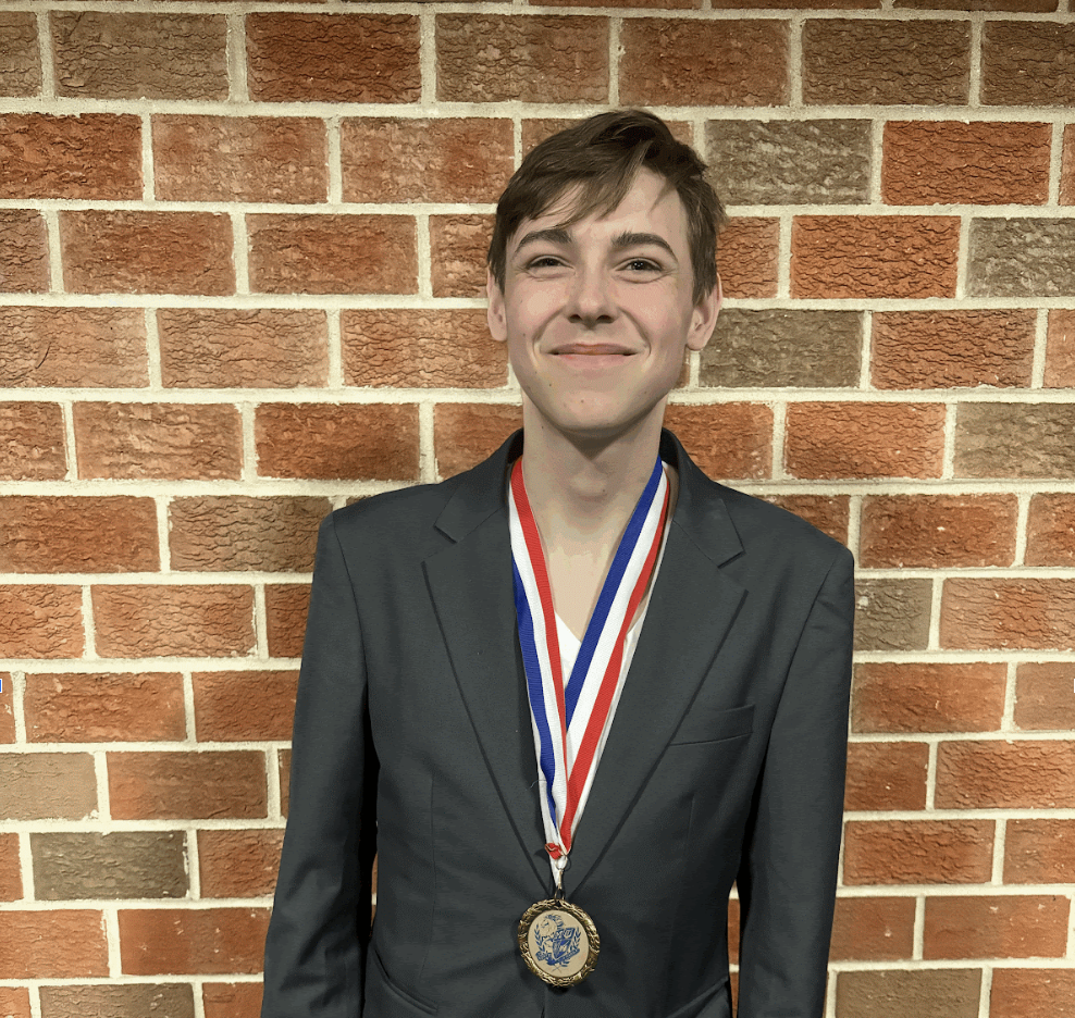 Smiling with Joy: Evan Baatz (Alum '25) smiles with joy after winning a medal in Speech.

